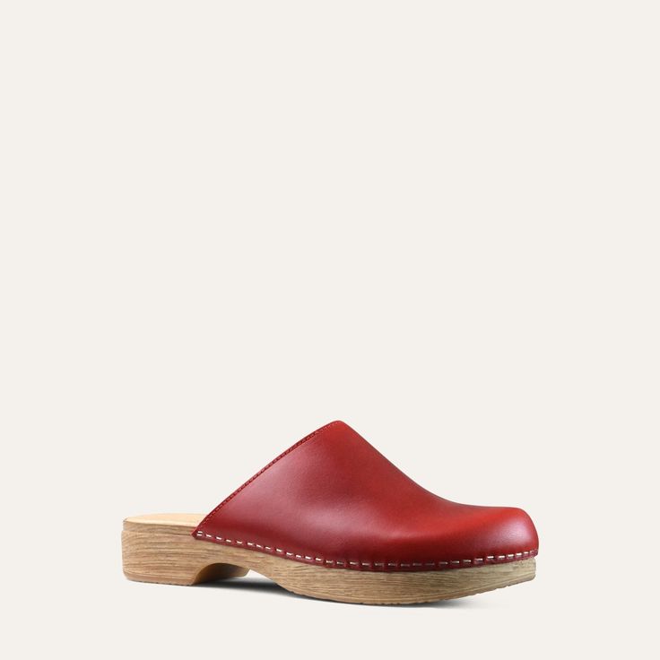 The Helena classic clog is one of our all-time favorites. It has the look of a traditional clog but on a flat base. Red leather. With its cushioned, flexible sole, the Helena clog is both stylish and easy to wear. Designed in Sweden and handmade in Italy. Heel: 3cm / 1.18" Inches Soft Padded footbed Flexible base with wood-like effect Classic Slip-on Clogs With Leather Sole, Slip-on Clogs With Leather Footbed And Flat Heel, Classic Slip-on Clogs With Rubber Sole, Classic Slip-on Clogs With Cushioned Footbed, Slip-on Clogs With Rubber Sole And Plain Toe, Slip-on Clogs With Leather Sole, Classic Leather Sole Slip-on Clogs, Leather Sole Slip-on Clogs With Plain Toe, Classic Mules With Rubber Sole And Round Toe