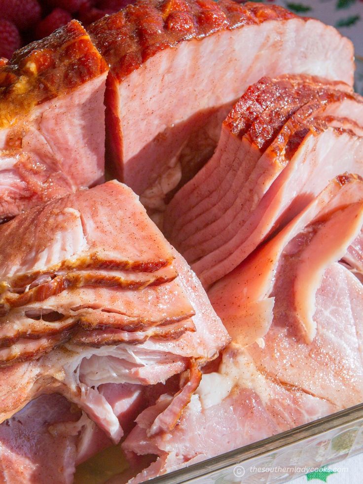 sliced ham and raspberries in a glass dish