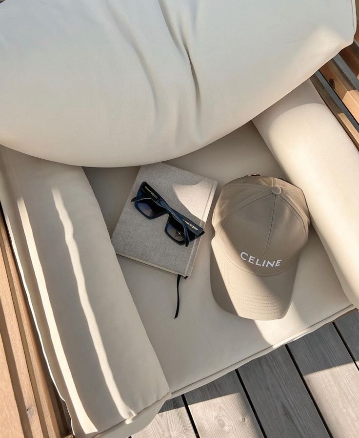 a hat, sunglasses and book on a boat