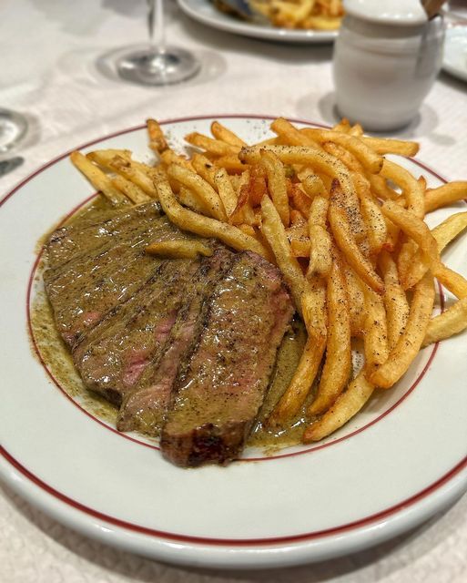 a steak and french fries on a plate