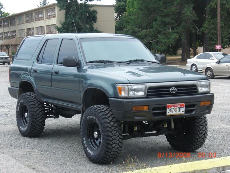 a large green truck parked in a parking lot