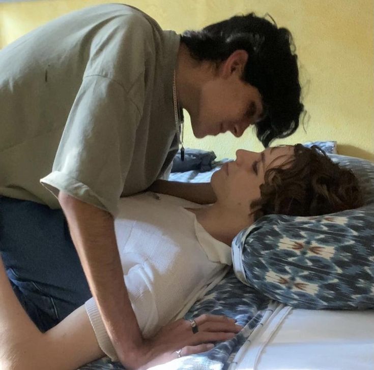 a man kissing a woman on the bed