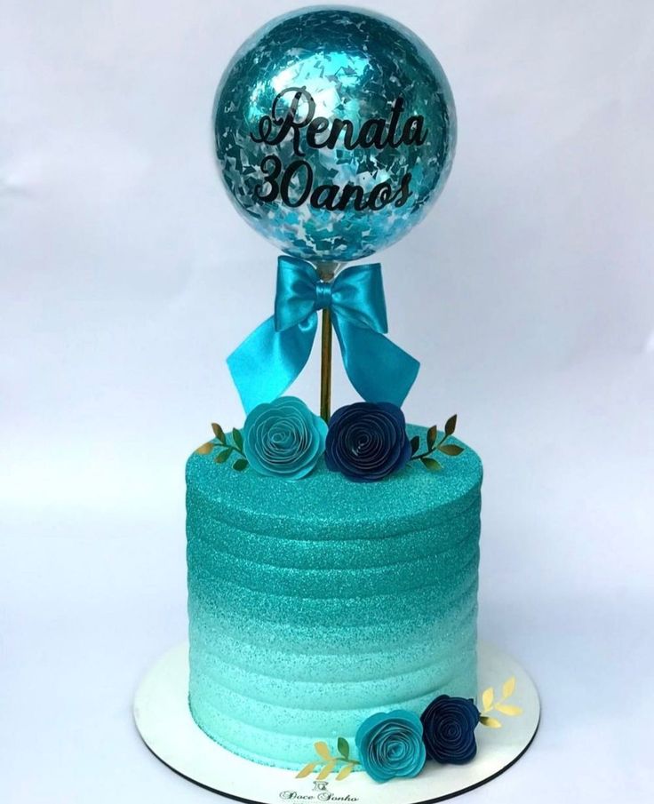 a blue cake with a large balloon on top