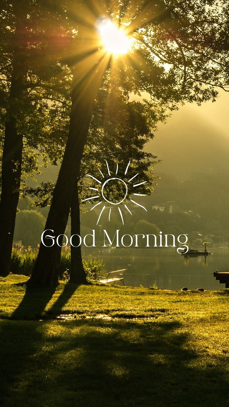 the words good morning are displayed in front of trees and water with sun rays coming through