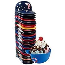 an ice cream sundae sits in front of a stack of plastic plates and bowls