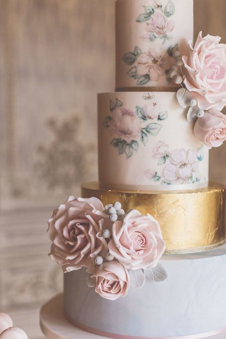 a three tiered cake with pink flowers on it