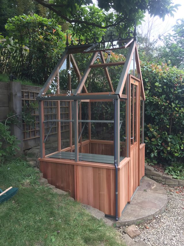 an outdoor hot tub in the middle of a garden