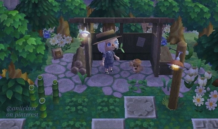 an animal crossing game in the middle of a forest with flowers and trees around it