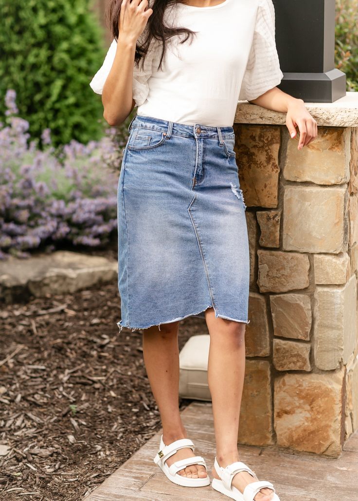 The Tiana Distressed Denim Midi Skirt is a modest and cute denim midi skirt! Designed with backed distressing at the front and back pockets, an uneven raw hem, 5 pockets for holding all the things, and a classic button zipper closure. Style: distressed, denim, midi length Color: Denim Quality control is of the utmost importance to us. Our sizing is always approximate and can also depend heavily on your own body shape. Just like no two people are the same, the same goes for skirts, dresses + tops. Please allow a 1" variance when ordering. Medium Wash Relaxed Skirt With Frayed Hem, Dark Wash Distressed Cutoff Denim Skirt, Distressed Dark Wash Cutoff Denim Skirt, Relaxed Denim Skirt With Frayed Hem, Denim Skirt With Frayed Hem And Relaxed Fit, Spring Denim Skirt In Dark Wash With Unfinished Hem, Spring Dark Wash Denim Skirt With Unfinished Hem, Spring Relaxed Denim Skirt With Frayed Hem, Spring Denim Skirt With Frayed Hem And Relaxed Fit