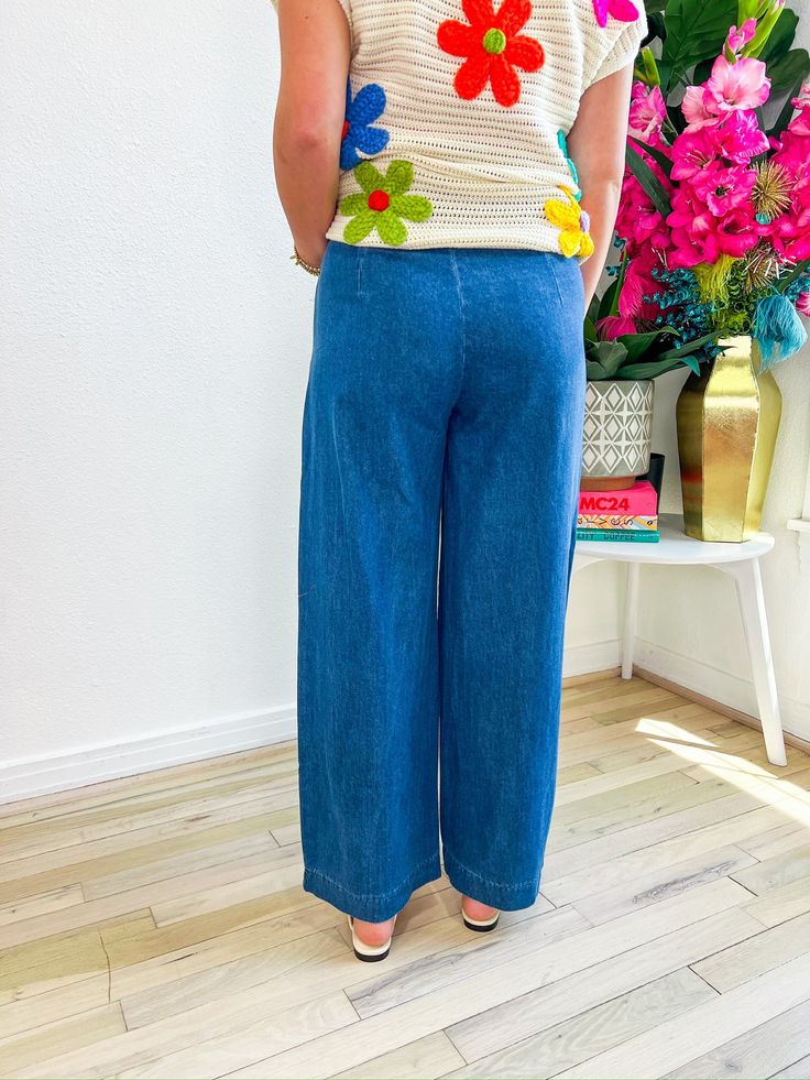 Step into style with the Rose Pants, where dark denim meets flair! These jeans boast a striking double row of buttons down the front, adding a touch of chic detail. Plus, they feature a handy zipper closure on the side for effortless wear. Whether you're rocking a casual look or aiming for a touch of sophistication, these pants are your go-to choice for adding that extra dash of style to any outfit! PRODUCT FIT - TRUE TO SIZE MODEL DETAILS - BRENNA IS A SIZE SMALL, 5'3" WAIST - SMALL 29", MEDIUM Spring Wide Leg Dark Wash Cropped Jeans, Denim Cropped Leg Bottoms With Button Zip Fly, Denim Blue Wide Leg Pants With Button Zip Fly, Dark Wash Cropped Jeans For Spring, Dark Wash Cropped Jeans With Button Closure For Spring, Spring Medium Wash Pants With Button Zip Fly, Dark Wash Wide Leg Pants With Button Closure, Wide Leg Pants With Button Closure In Medium Wash, Medium Wash Wide Leg Pants With Button Closure