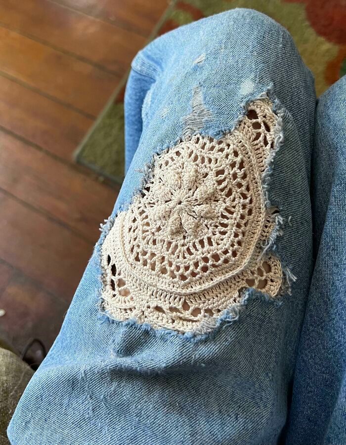 someone is wearing jeans with crochet on them