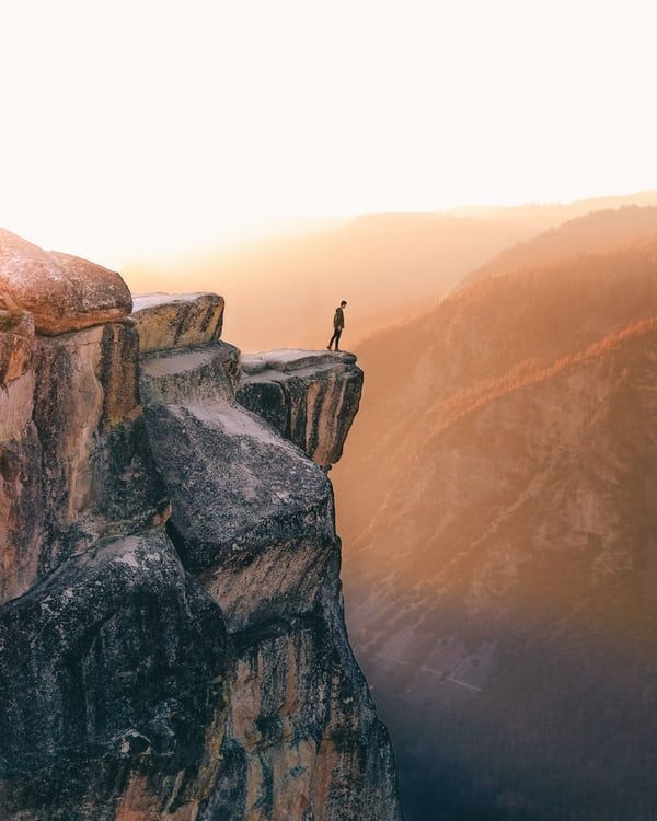 a man standing on the edge of a cliff