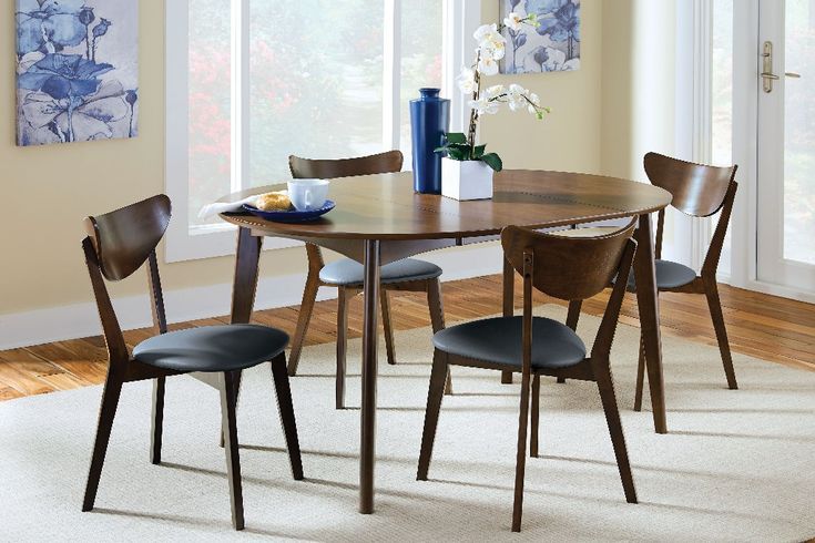 a dining room table with four chairs around it