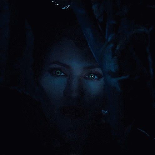 a woman with blue eyes in the dark