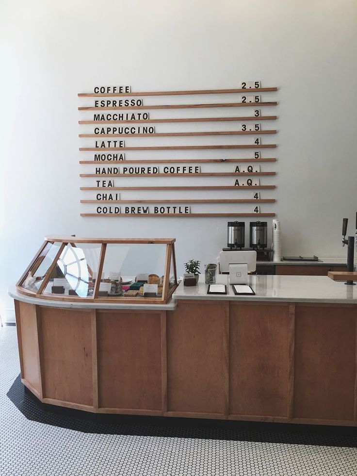 a coffee shop counter with lots of writing on the wall above it and below it