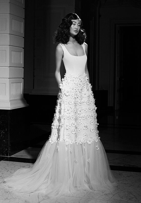 a black and white photo of a woman in a wedding dress with flowers on it