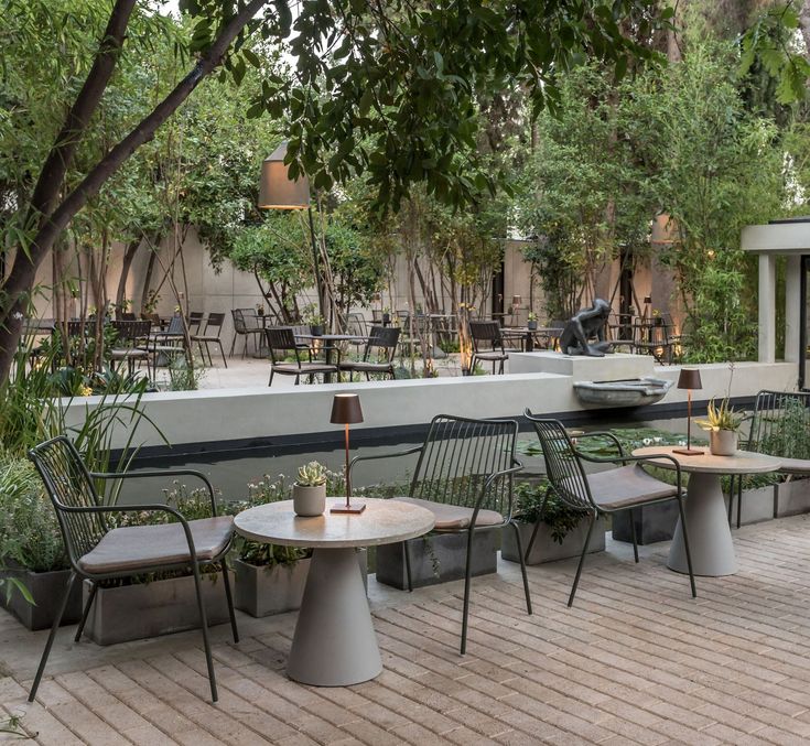 an outdoor seating area with tables and chairs