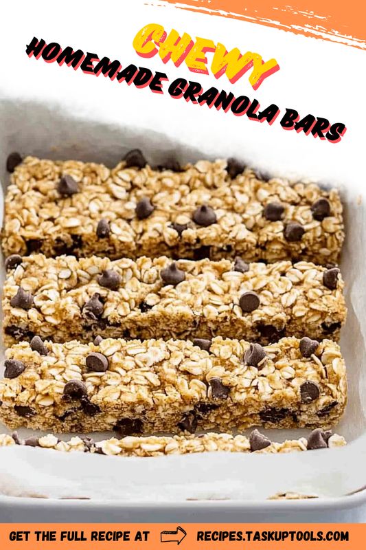 homemade granola bars with chocolate chips and oats in a baking pan on an orange background