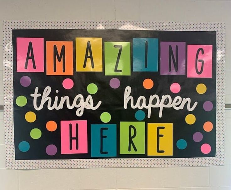 a sign that says amazing things happen here on the front of a door with polka dots