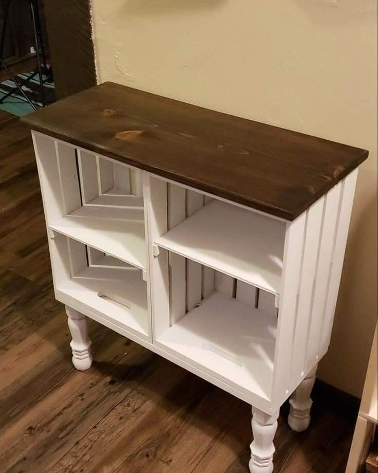 a white cabinet with shelves on top of it in a room next to a wall