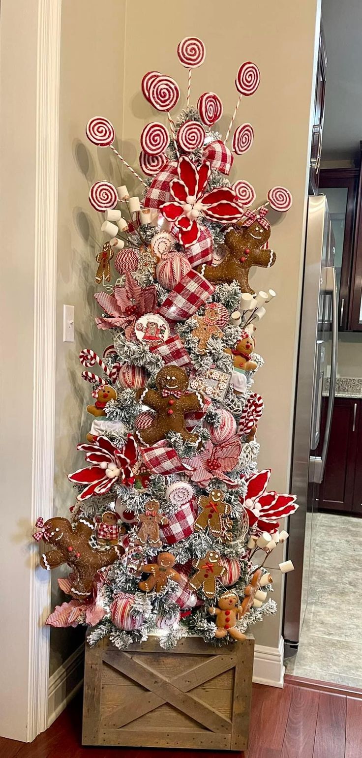 a christmas tree decorated with candy canes and candies is shown in the entryway