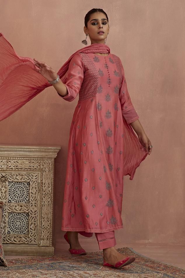 Coral A-line kurta featuring thread embroidery and a round neckline. Paired with cotton pants and a slip., Fit: Relaxed Slub Silk Salwar Kameez With Chikankari Embroidery, Unstitched Mulmul Suit With Self Design, Cotton Silk Anarkali Set With Resham Embroidery, Eid Slub Silk Palazzo Set, Cotton Silk Churidar For Transitional Season, Embroidered Cotton Silk Churidar, Transitional Chanderi Churidar, Festive Mulmul Salwar Kameez, Unstitched Chanderi Suit With Self Design