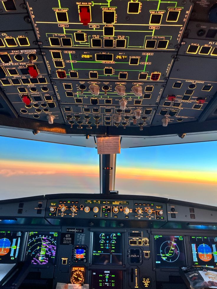 the view from inside an airplane cockpit at sunset