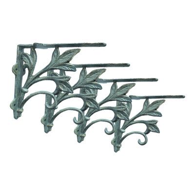 three metal brackets with leaves and vines on each one, set against a white background