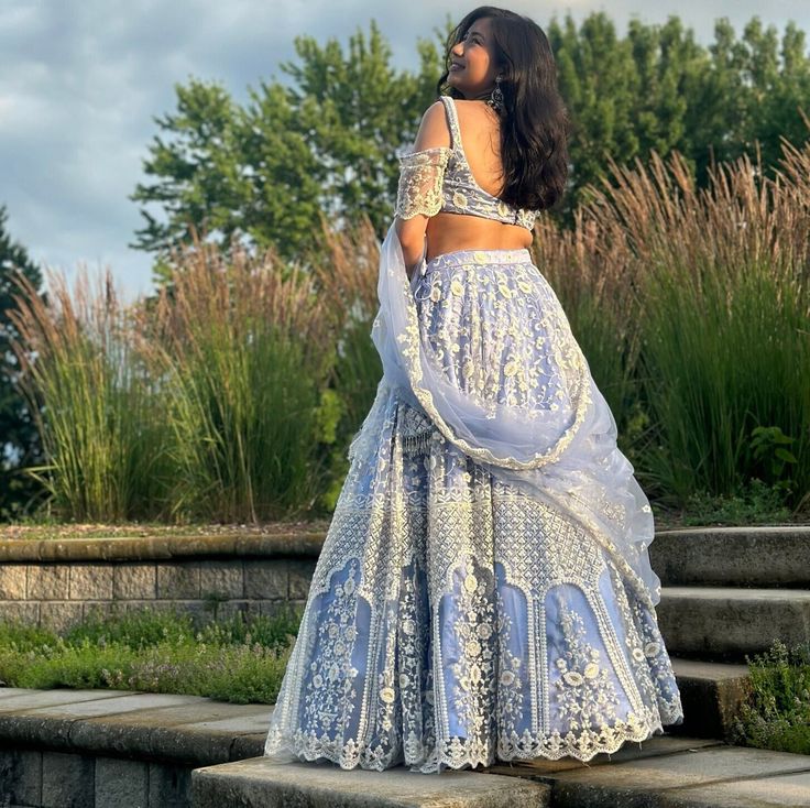 This outfit is made up of a high quality tulle fabric. Blouse has inner fabric of cotton, while the bottom skirt has outer layer of tulle fabric, silk satin wrapped around inside, along with Buckram in the innermost layer to give a sturdy flow and shape and perfect structure needed for a Lehenga. The shawl is the same: Tulle fabric. Whole fabric has Sequin embroidery work along with the thread work. Blouse has a cold shoulder sleeve style. Cinderella Lehenga, Elegant Fitted Organza Lehenga, Sheer Organza Wedding Sets, Sheer Organza Sets For Wedding, Fitted Sheer Set For Wedding, Festive Fitted Organza Skirt, Elegant Fitted Gown In Net Material, Evening Net Lehenga Fitted Style, Fitted Net Lehenga For Evening