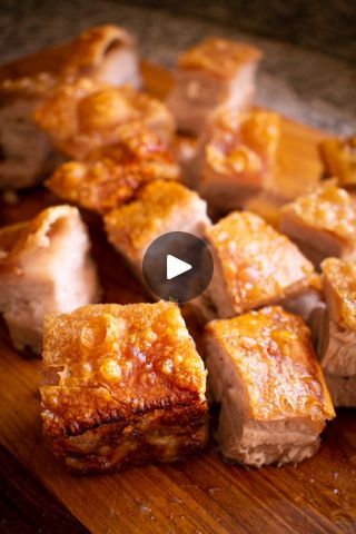 some food that is sitting on a cutting board and being cut into cubes with one bite taken out