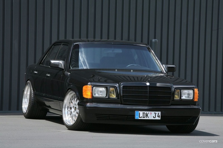 a black mercedes benz parked in front of a building