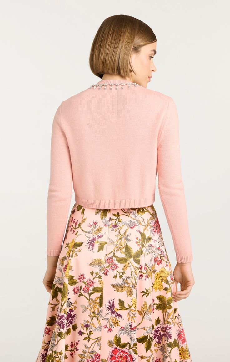 Elevate your style with our Isolde Embroidered Cardigan. This cropped cardigan features an intricately embellished neckline and vibrant embroidered floral design. Made with a luxurious wool blend, it's perfect for adding a touch of elegance to any outfit. Available in a lovely shade of pink. Details Button front closureFabric: Floral EmbellishedCropped silhouetteEmbellished and embroidered detailsLong sleeve Content and Care 70% Acrylic 30% WoolDry CleanImported Measurements 17.5in/44.45cm from Elegant Embroidered Spring Sweater, Elegant Embroidered Spring Cardigan, Chic Embellished Spring Sweater, Elegant Floral Embroidered Winter Cardigan, Embellished Long Sleeve Cardigan, Embellished Fitted Sweater For Spring, Elegant Cropped Cardigan For Spring, Elegant Embroidered Winter Cardigan, Elegant Cropped Winter Cardigan