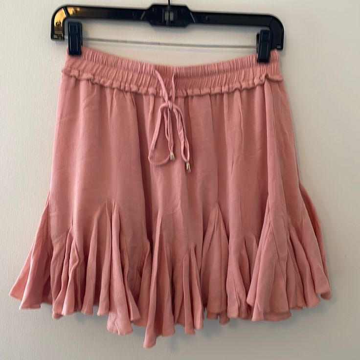 Mid Waist Pink Ruffle Skirt, Brand New With Tags. Elastic Bank With An Adjustable Tie. Flowy And On The Shorter Side. Purchased From A Small Boutique In Nc. Feminine Flowy Bottoms With Ruffle Hem, Flowy Feminine Bottoms With Ruffle Hem, Summer Skirted Bottoms With Ruffle Hem, Feminine Flared Skirt Bottoms With Ruffle Hem, Beach Skirt With Ruffles And Stretch Fit, Beach Skirt With Ruffles And Stretch, Beach Skirt With Stretch And Ruffles, Casual Ruffle Hem Skirt For Day Out, Summer Skort With Ruffles