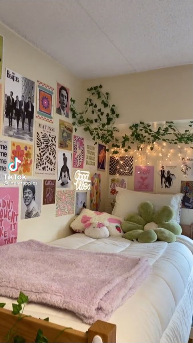 a bedroom with posters on the wall and bed