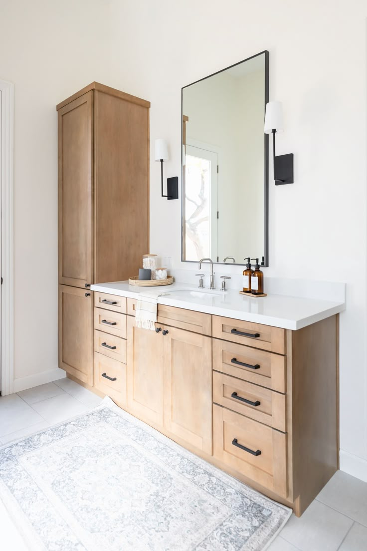 a bathroom with two sinks and a large mirror above the vanity area in front of it