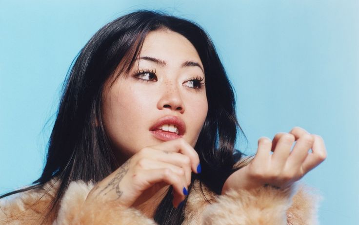 a woman in a fur coat posing for the camera