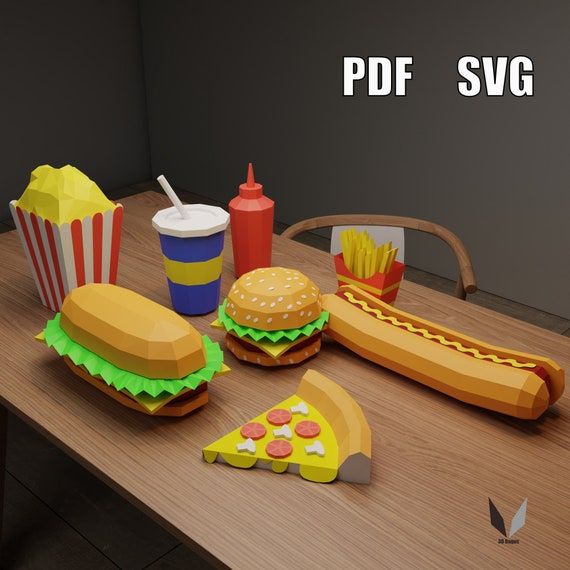 a wooden table topped with paper cutouts and hot dogs, hamburgers, fries, and soda