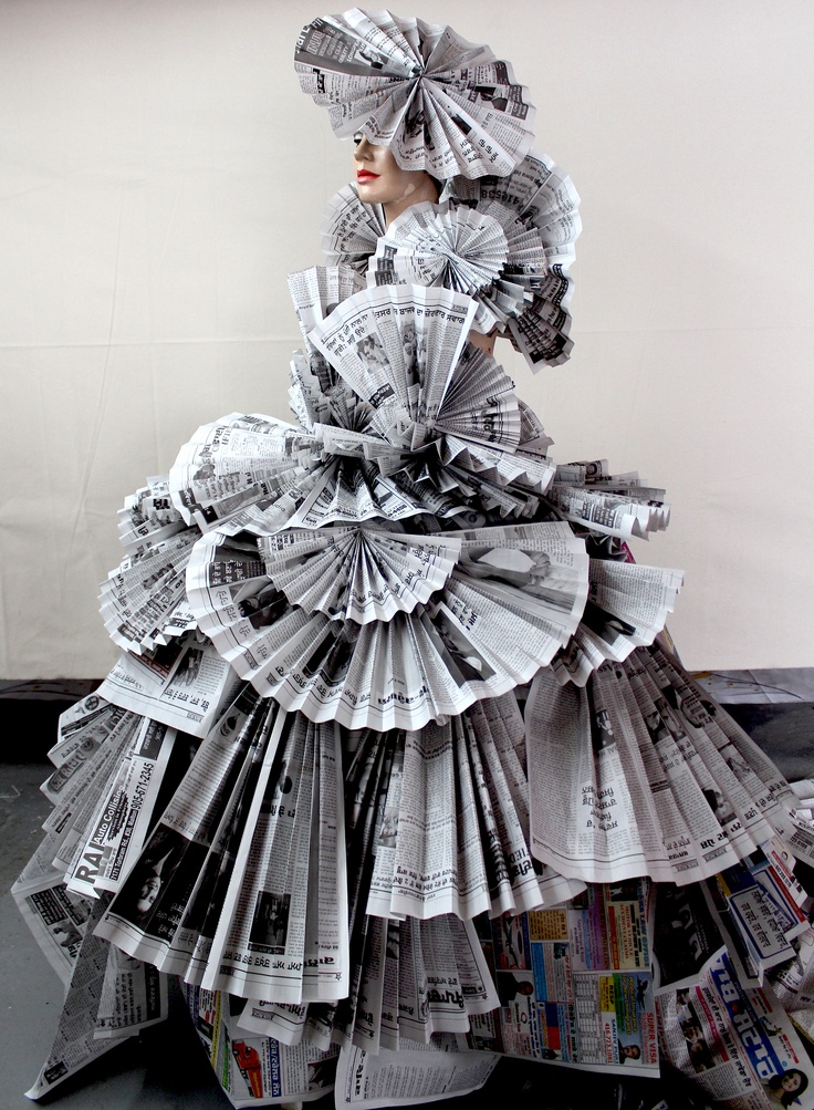 a woman in a dress made out of newspapers