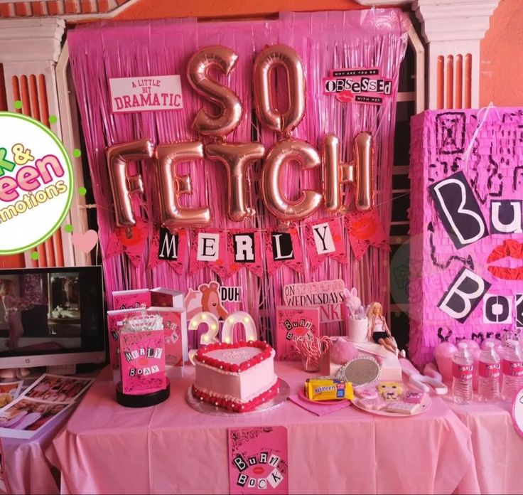 a table with pink decorations and balloons for someone's 30th birthday or baby shower