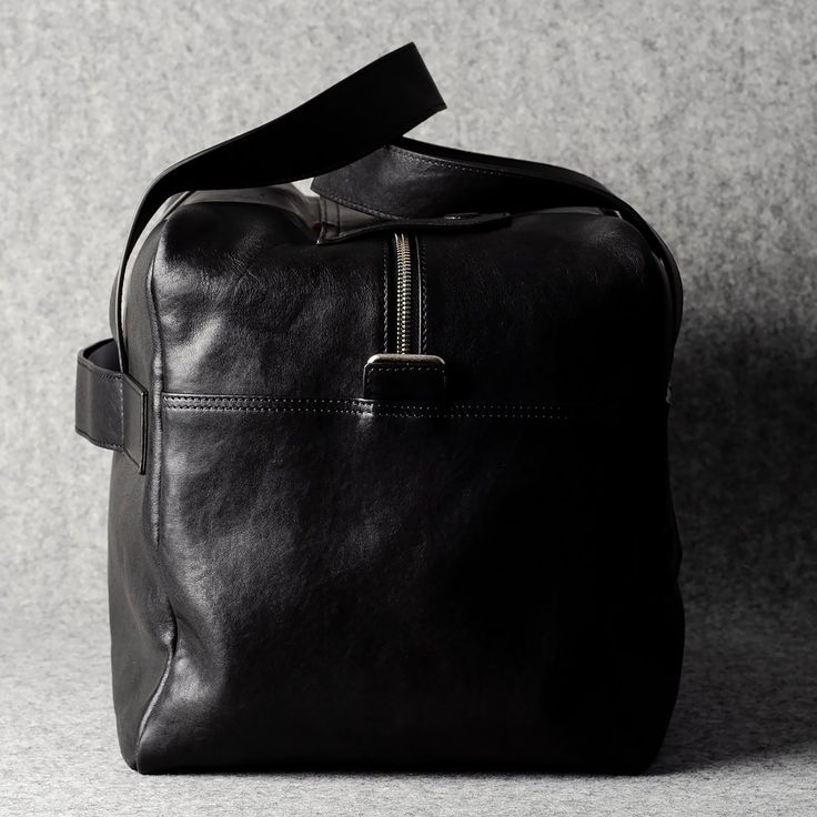 Made in Italy, this overhead bag is a versatile carry-on bag that is as useful as it is good-looking. The bag features rich black vegetable-tanned leather and has one large external zip pocket hidden underneath a large flap and an adjustable and removable shoulder strap. There's also a strip of leather on the back to attach the bag easily to your suitcase while traveling. Timeless and well-made, it's built to stand the test of time and be a trusty weekender for years to come.