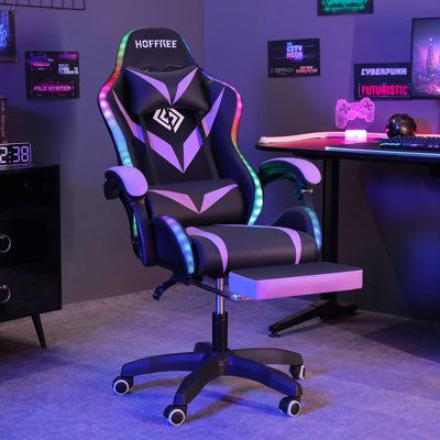 a gaming chair sitting in front of a computer desk with neon lights on the back