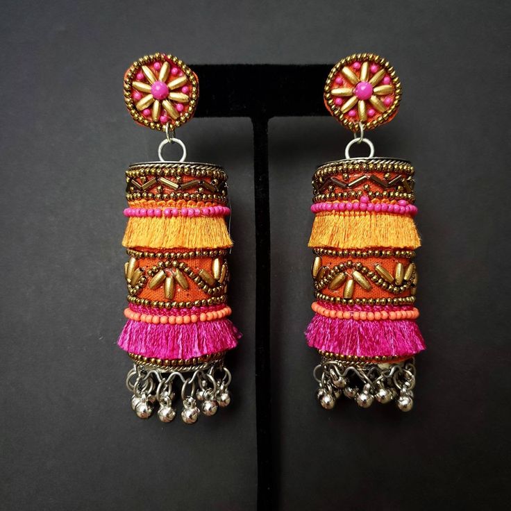 Fun and playful Afghani fringe earrings, with gold tone bead work. The perfect summer earring, colorful and carefree. Fabric backed ear stud ensures a comfortable fit. The main body is fabric wrapped around a metal cylinder. Beautiful vibrant colors. Little bells make a lovely sound when you move your head. Weight 21 gm. Find even more great earrings here: https://www.etsy.com/shop/boutiquebymaryam?section_id=22797814 Be sure to visit the rest of my shop here: https://www.etsy.com/shop/boutiqueb Ghungroo Jewellery, Bellydance Jewelry, Afghani Jewelry, Fabric Necklaces, Silk Thread Earrings, Metal Cylinder, Oxidised Silver Jewelry, Belly Dance Jewelry, Fabric Jewellery