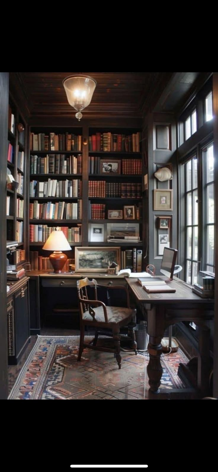 an old fashioned home office with lots of bookshelves