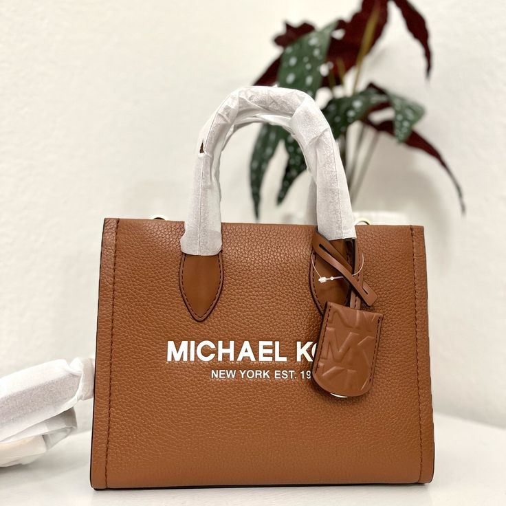 100% Michael Kors Authentic Guarantee And Firm Price! Details Crossbody Bag Pebbled Leather 100% Leather Gold-Tone Hardware 9.25”W X 7.75”H X 3.75”D Handle Drop: 3.25” Adjustable Strap: 20.25”-23.75” Interior Details: Back Zip Pocket, Front Slip Pocket Lining: 100% Polyester Zip Fastening Imported Pebbled Leather Shoulder Satchel For Shopping, Pebbled Leather Shoulder Bag Satchel For Shopping, Rectangular Pebbled Leather Satchel For Shopping, Trendy Leather Bags With Branded Hardware, Medium Leather Shoulder Bag For Errands, Rectangular Pebbled Leather Shoulder Bag For Shopping, Pebbled Leather Crossbody Bag For Shopping, Classic Textured Leather Satchel For Errands, Tan Textured Leather Bag For Errands