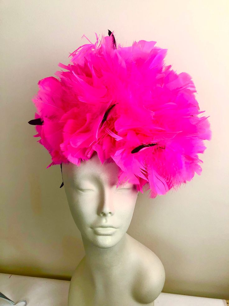 Hot Pink Fascinator- Pink Headband- Feathers- Tea party- Handmade in USA- Mardi Gras- Cocktail hat Hello,   This hot pink Headband has a feather pouf about 12 inches round and some black feathers inside for accents.  It's all attacked to a 1/8" satin ribbon wrapped skinny headband. The headband is adjustable to fit any head size and very comfortable. Plus, new technology ...no more headaches -------------------------------------------------- I ship US Postal Service.     USA DOMESTIC CHOICES (From mailed date in business days) first Class:  Arrives 3-6days. (No insurance) Priority:        Arrives 1-3 days.  (Insurance included)                   Express:       Arrives 1-2 days.  (Insurance included)  INTERNATIONAL CHOICES (From mailed date in business days) First Class:  Arrives 10-26 days Mardi Gras Cocktails, Pink Fascinator, Pink Headband, Feather Fascinator, Bride Hat, Feather Fascinators, Pink Headbands, Feather Hat, Cocktail Hat