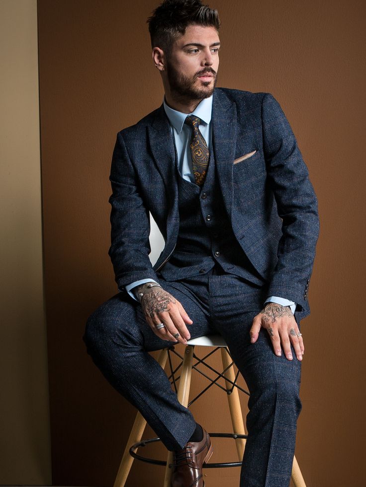 The Sam Reece collection features some amazing new suit styles with bold patterns, statements checks and cutting edge pinstripe in slim or skinny fit cuts. Plus we showcase the hottest tailoring trends of 2018 with many of our three piece suits including horseshoe style and double breasted waistcoats. Tattoo Men In Suits, Patterned Suits For Men, Pattern Suit Men, Trending Suits For Men, 1950s Groom Attire, Patterned Suit, Mens Suits Style, Suit Styles For Men, Men Suits Style