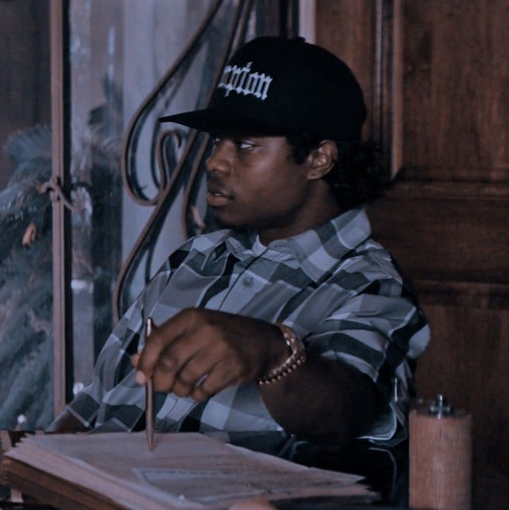 a man sitting at a desk with a pen in his hand