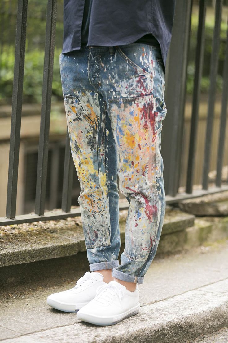 a person standing on the steps with their hand in his pocket