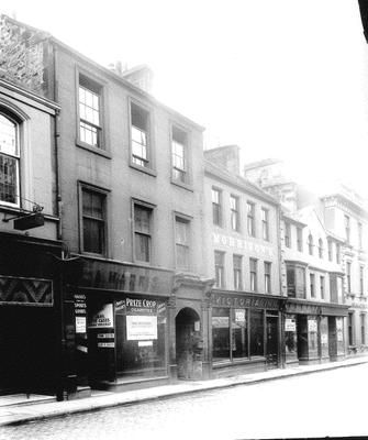 an old black and white photo of buildings on a city street in the early 20th century