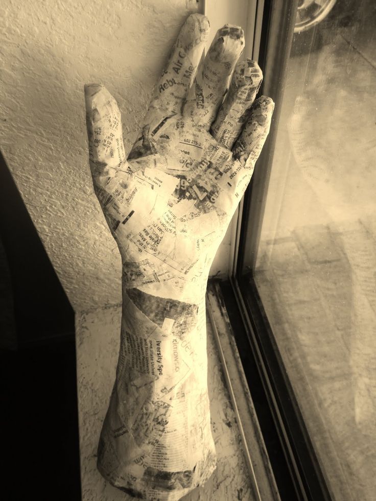 a hand that is sticking out of the side of a window sill with writing on it